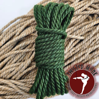 Green hemp bondage rope coiled neatly for secure tying and restraint purposes