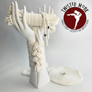 Ivory hand-spun bamboo rope displayed on a sculpted hand for bondage and artistic use
