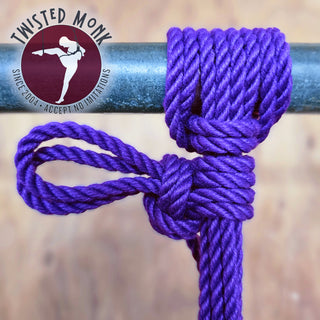 Laingman purple bondage rope with a secure knot on a metal pole for versatile tying applications