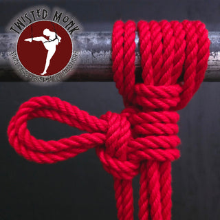 Red POSH bondage rope tied securely on a metal bar for bondage enthusiasts