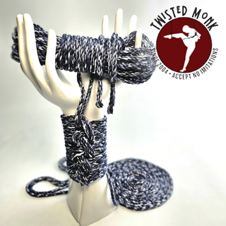 The Twisted Monk steel hand-spun bamboo rope in blue and black colors displayed on a hand mannequin.