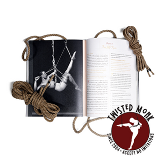 Open book on bondage techniques for all bodies with illustrated examples and two ropes beside it