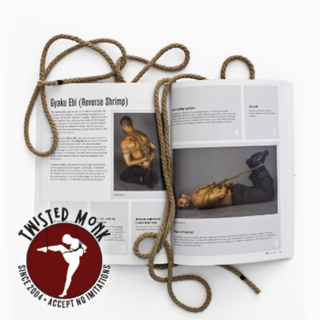 Japanese rope bondage book shibari opened to Gyaku Ebi technique with tied model and rope