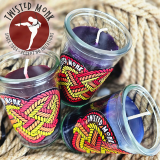 Bondage candles and accessories displayed in vibrant glasses for enhancing intimate experiences