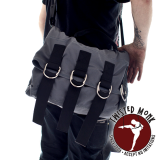 MonkSak bondage bag shown on a person, featuring durable fabric and multiple attachment rings for versatile use
