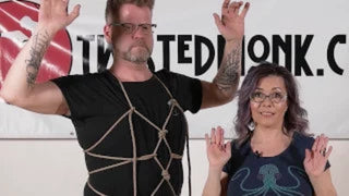 Alien Baby harness tutorial featuring two instructors demonstrating the harness technique on a model