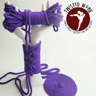 Purple hand-spun bamboo rope displayed on a mannequin hand by The Twisted Monk for bondage and crafting