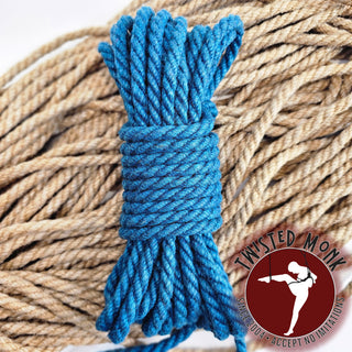 Blue robust bondage rope set coiled with natural fibers in the background for secure restraint options