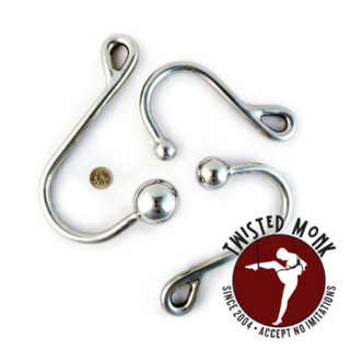 Three shiny metal bondage ass hooks by William C. Steel for secure and versatile attachment in BDSM